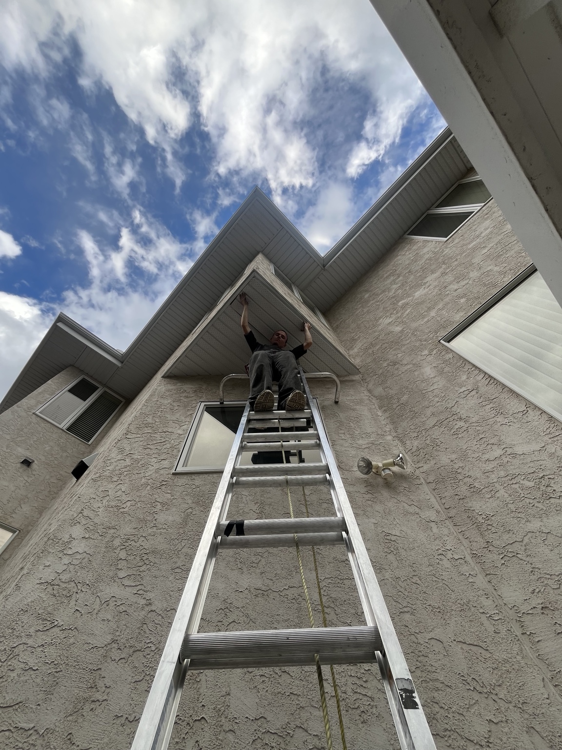 Re-Gutter technician working along a residential roofline