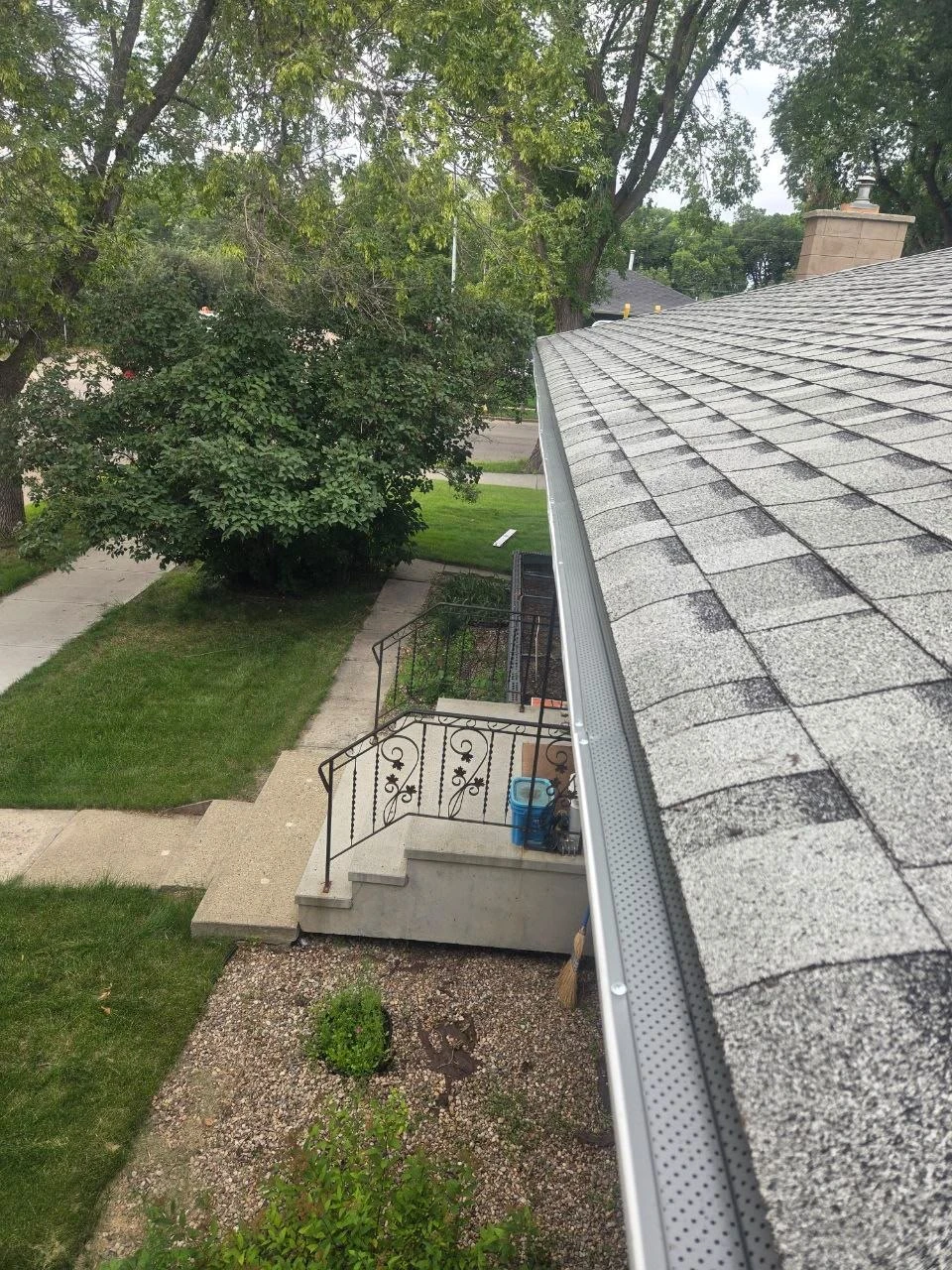 Gutter guard fitted along a residential roofline